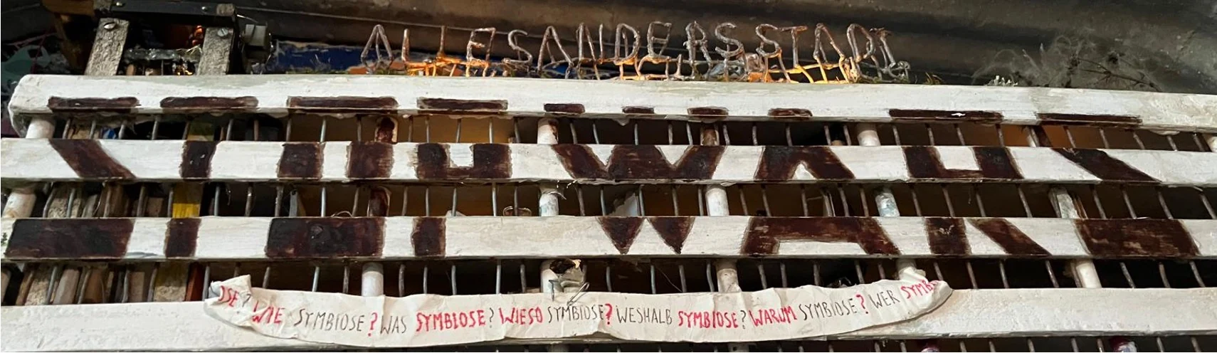 Detail of the STOP WARS window with the handmade ALLESANDERSSTADT title