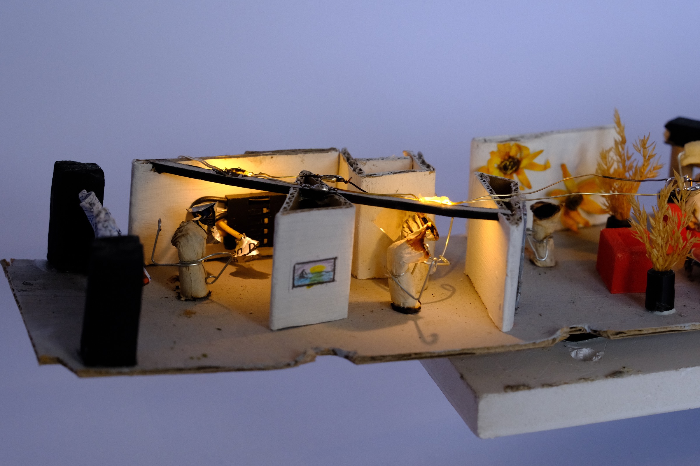 Cigarette figures standing before an empty exhibition wall