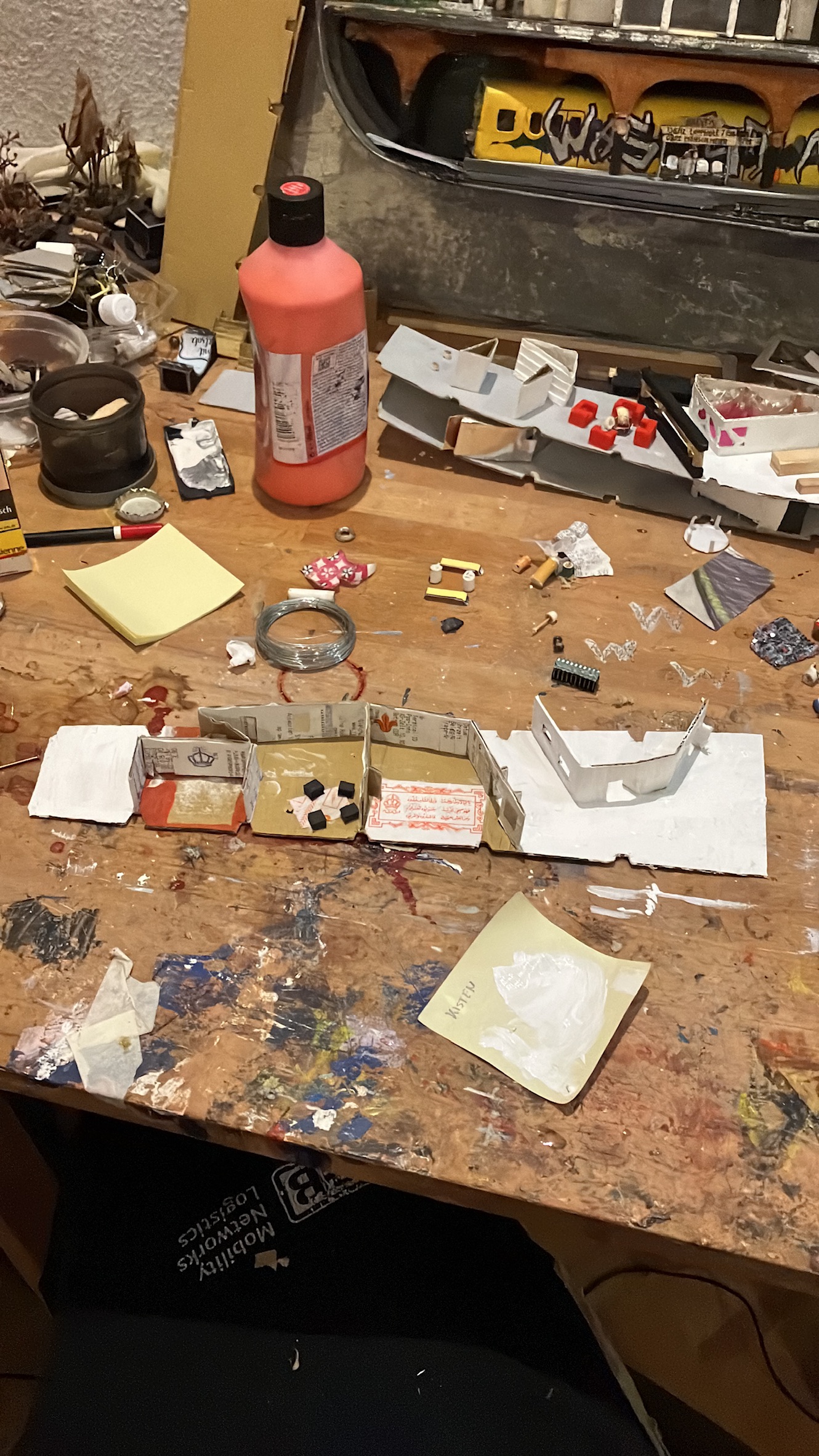 Living room floor under construction from cardboard and collected papers